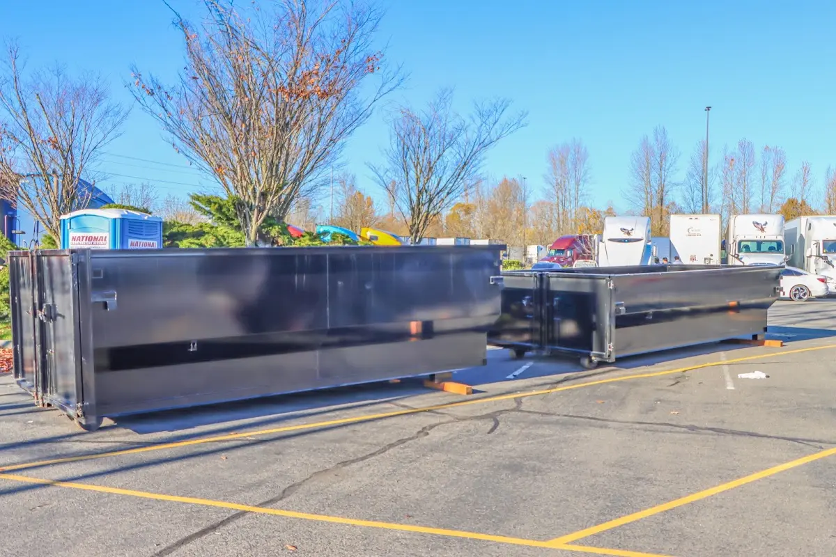 Professional dumpster rental service with roll-off container on residential driveway in Gainesville